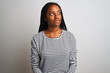 © Krakenimages.com - Young african american woman wearing striped t-shirt standing over isolated white background smiling looking to the side and staring away thinking.