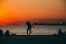 Golden Sunset And Silhouette Of Skaters In Rio De Janeiro, Brazil