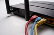 © MuhammadSyafiq - Backside view of dual band wifi router with cat-6 cable connected to the modem. Internet security conceptual