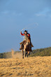 © Westend61 - USA, Wyoming, riding cowboy swinging lasso
