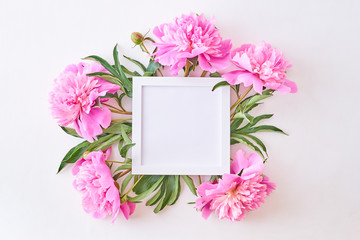 Wall Mural - Mockup square white frame with pink peonies on a white background