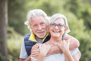 portrait of happy and cheerful healthy caucasian old senior man and woman - elderly people together 