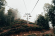 © Cavan Images - Cable car in the foggy forest