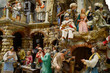 Whimsical creche scene of people in Bethlehem village including holy family and Magi