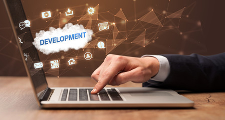 businessman working on laptop with development inscription, modern technology concept