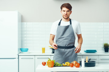 Wall Mural - man preparing food in the kitchen