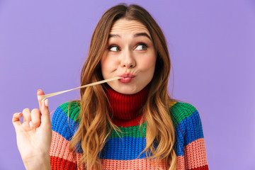 Sticker - Lovely young girl wearing colorful sweater eating chewing gum