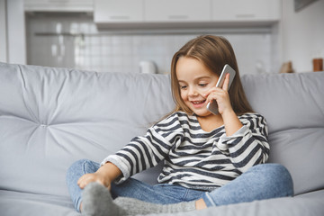 little kid girl at home childhood concept phone call