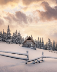 Wall Mural - fantastic winter landscape with wooden house in snowy mountains. christmas holiday concept. carpathi