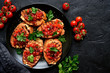 Grilled toasts with tomato salsa. Top view with copy space.