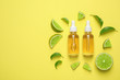 © New Africa - Flat lay composition with lime essential oil on yellow background. Space for text