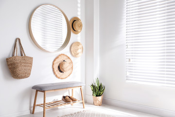 Poster - stylish round mirror hanging on white wall in room