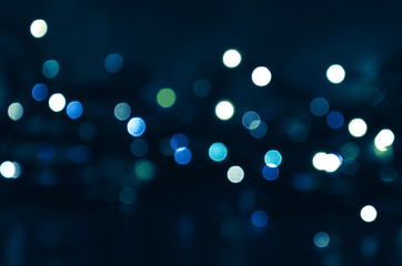 dark blue background with blue and green bokeh lights