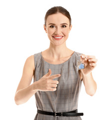 Wall Mural - Female real estate agent with key on white background