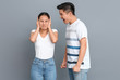 © Pixel-Shot - Quarrelling Asian couple on grey background