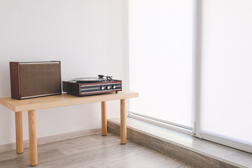 Wall Mural - Record player on table near window