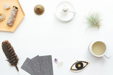 Tarot cards on a white background. Reading, feathers, crystals, tea.