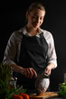 © Anton - Chef cleans fish on a background with ingredients for cooking fish. Sale of fish and seafood. Vertical frame.