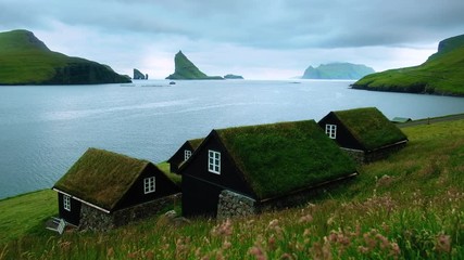 Wall Mural - Picturesque view of tradicional faroese grass-covered houses in the village Bour during summer. Vagar island, Faroe Islands, Denmark. UHD 4k video