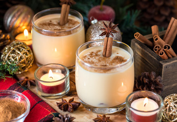 Two glass mugs of eggnog and cinnamon.