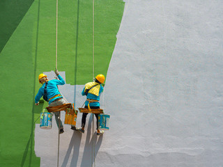 Painters painting exterior of building