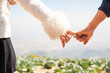 Filtered image, couple holding hands in wedding outdoor theme,Hand to pinky swear warm retro tone- Focus on hands