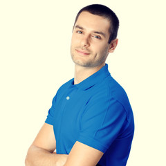 Wall Mural - Portrait of smiling young man, isolated on yellow background