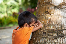 Filipino Boy Playing Hide And Seek At The Beach Of Palawan