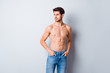 © deagreez - Photo of handsome macho man guy topless sporty torso metrosexual hot tender body holding hands in pockets looking side attentively wear jeans isolated grey background
