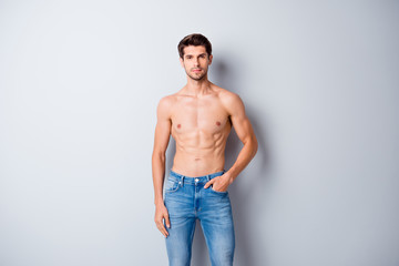 Portrait of his he nice attractive content muscular shirtless guy dandy perfect figure form shape pecs wearing jeans isolated over light white gray color pastel background