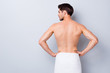 © deagreez - Back rear profile side photo of handsome macho man stand look copyspace after gym training gym shower feel skin smooth silky have white towel isolated over grey color background