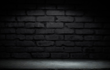 Wood table in front of rustic brick wall blur background with empty copy space on the table for product display mockup. Retro design montage presentation.