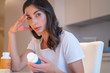 © Viacheslav Yakobchuk - Tired woman choosing pills and vitamins stock photo