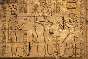 Hieroglyphic carvings on the exterior walls of an ancient egyptian temple