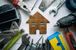 © SkyLine - A lot of different rapair equipments on the wooden table and a little wooden house between them