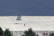 military helicopter lands in the landing zone