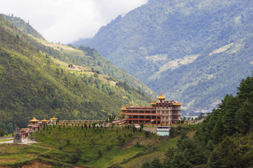 Tibetan-style monastery stands on a hill surrounded by forest, photo taken in the Indian state of Arunachal, Dirang village