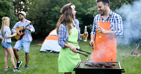 Wall Mural - Friends spending time in nature and having barbecue