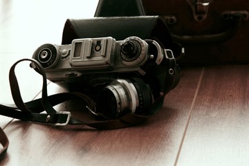 old retro film photo camera on the wooden floor