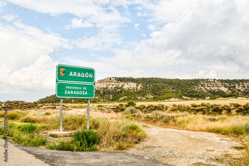 Fotomural sign on road in mountains, photo as a background