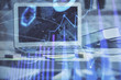 © peshkova - Forex market chart hologram and personal computer background. Double exposure. Concept of investment.