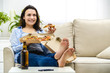 © Andrii - Beautiful and happy woman is eating pizza. She is smiling sincerely, while sitting on the sofa. Copy space.