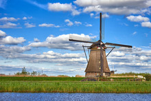 Beautiful Dutch Windmill Under The Cloudy Sky In Kinderdijk