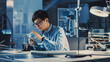© Gorodenkoff - Professional Japanese Electronics Development Engineer in Blue Shirt is Soldering a Circuit Board in a High Tech Research Laboratory with Modern Computer Equipment.
