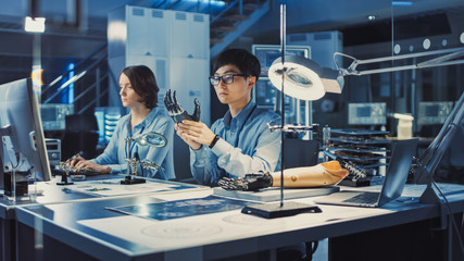 Poster - Technological Prosthetic Robot Arm is Tested by Two Professional Development Engineers in High Tech Research Laboratory with Modern Futuristic Equipment. Man, Female Compare Data on Personal Computer