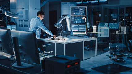 Poster - Professional Japanese Development Engineer is Testing an Artificial Intelligence Interface by Playing Chess with a Futuristic Robotic Arm. They are in a High Tech Modern Research Laboratory.