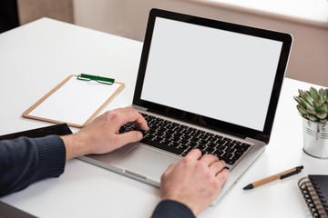 Wall Mural - Laptop with white blank screen on a wooden desk