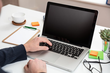 Wall Mural - Laptop with black blank screen on a wooden desk