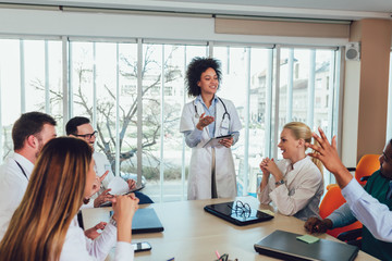 Medical team sitting and discussing at the table in the office.