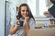 © cherryandbees - woman using laptop computer and drinking coffee in kitchen on kitchen counter